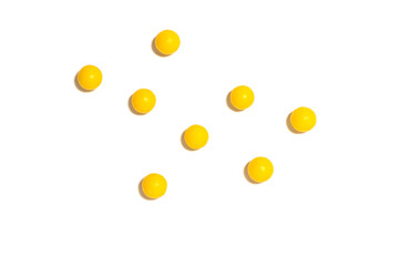 round yellow pills on a white isolated background