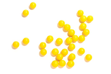 round yellow pills on a white isolated background