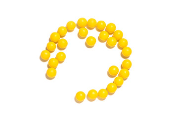 round yellow pills on a white isolated background