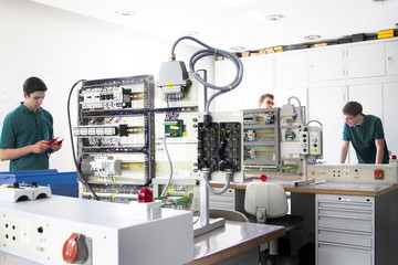 Three electronic apprentices at workshop