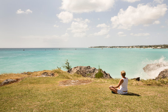 Caribbean, Barbados, woman sitting at the coast
