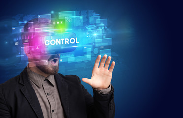 Businessman looking through Virtual Reality glasses with CONTROL inscription, innovative security concept