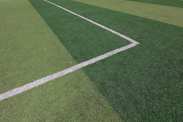 White markings on the green runway