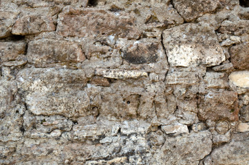Old stone wall made of hard stone	