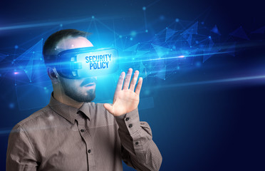 Businessman looking through Virtual Reality glasses with SECURITY POLICY inscription, cyber security concept