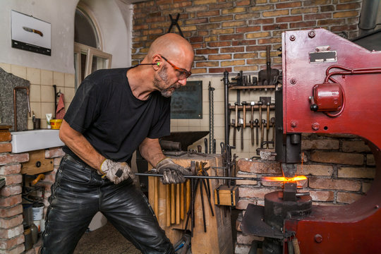 Knife maker in workshop at work