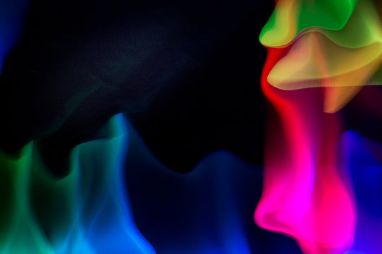 Vibrant rainbow made with lights on a dark background