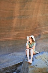 Young beauitufl hiker woman trekking natural orange mountain on summer holidays