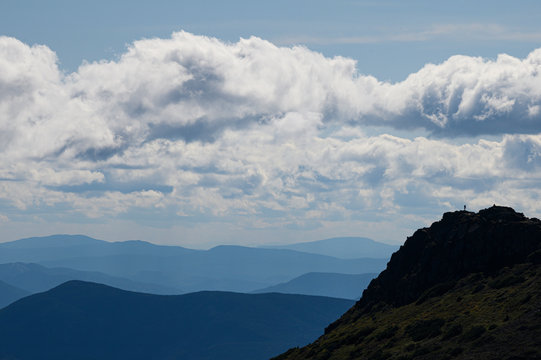 Lone hiker on the summit of Mount Monroe in the White Mountains of NH.