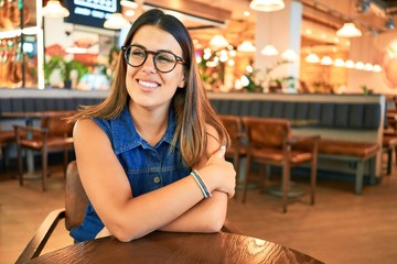 Young beautiful woman sitting at airport restaurant