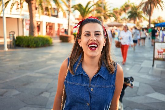 Young beautiful woman smiling happy walking on city streets of Puerto de la Cruz, Tenerife on a sunny day of summer