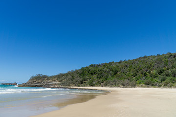 the beautiful beach of Noosa on the sunshine coast in Australia with beautiful weather and blue sky with white clouds