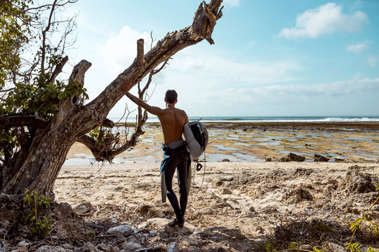 Surfer looking at wave - Powered by Adobe