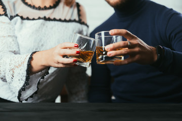 Young couple guy and girl drink whiskey on a date