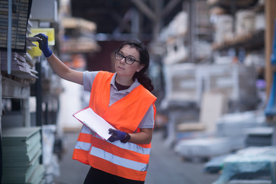 storekeeper female in a warehouse wit a tile