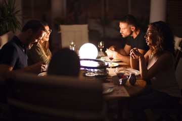 Beautiful family on dinner talking and smiling at terrace