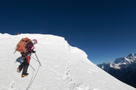 Woman climber ascends the final meters to Mera Peak's 21,247ft summit