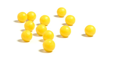 round yellow pills on a white isolated background