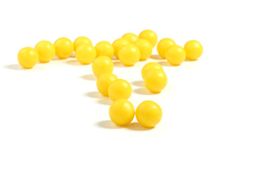 round yellow pills on a white isolated background