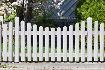 White garden wooden fence. Fragment of the white garden fence