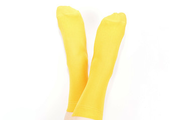 Yellow socks on woman foot isolated on white background.