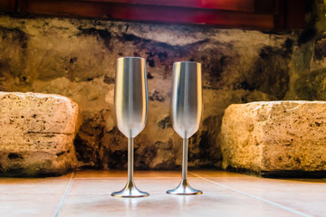 Two metal cups to toast with champagne in a romantic place