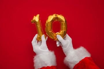 12 days of christmas. Santa hands holding 10th day balloon on red background