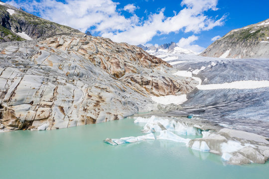 Rhone Glacier and glacial lake at its base in summer, aerial view, Gletsch, Canton of Valais