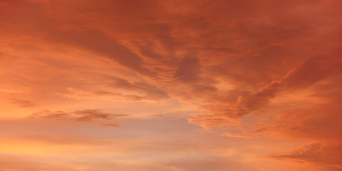 Naklejka na ściany i meble Orange and pink sky after sunset, nice clouds background