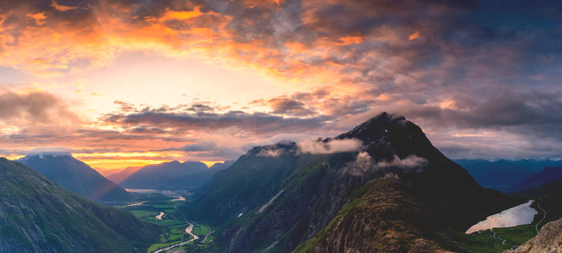 Fiery sky at sunset over Romsdalen and Venjesdalen mountains seen from Romsdalseggen Ridge, Andalsnes, More og Romsdal