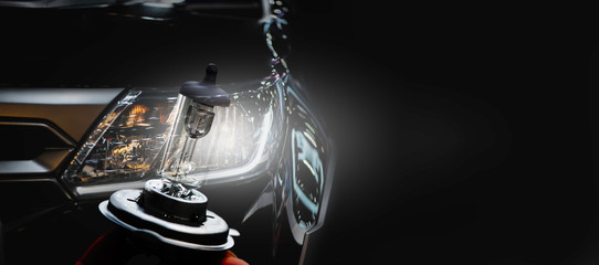 Modern sport car headlight with flare on the road.	