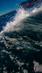 Splashes from the yacht in the sea water. Wake of a ferry boat