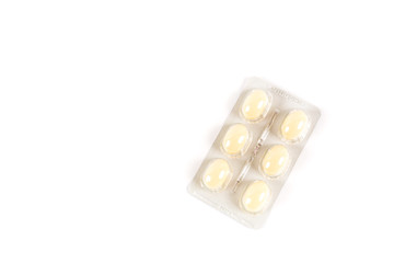 Tablets in strip over white background, vaginal antibacterial capsules