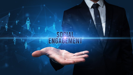 Elegant hand holding SOCIAL ENGAGEMENT inscription, social networking concept
