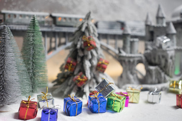 Miniature of winter scene with Christmas houses, train station, trees, covered in snow. Nights scene. New year or Christmas concept. Selective focus