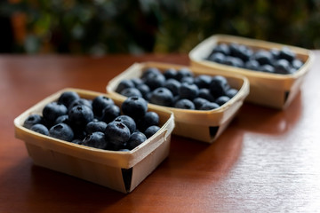 Blueberries lie on the table in portion boxes of birch bark. Delicious and healthy food contains a lot of vitamins. Russia.