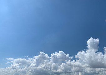 View of dense, heavy, big clouds and blue sky.