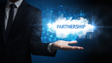 Obraz premium Hand of Businessman holding PARTNERSHIP inscription, successful business concept