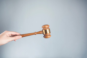 woman hand holding wooden judge