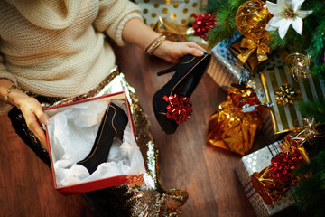 housewife holding christmas present box and black shoes