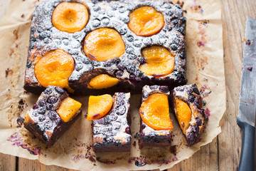 Blueberry apricot brownie cheesecake with icing sugar 