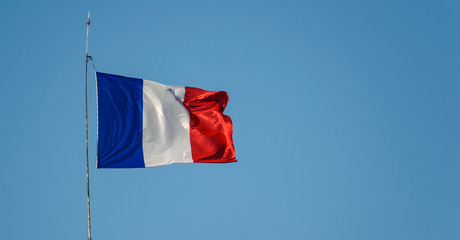 Flag of France waiving against sky on windy day
