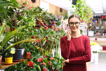 Female business owner talking on mobile phone in flower shop