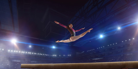 Fototapeta na wymiar Female gymnast on professional arena.