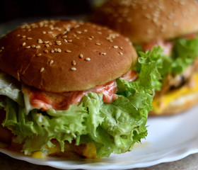 Hamburger on a white plate. Close-up