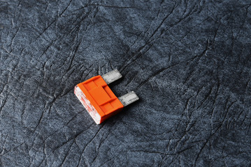 Burned car fuse in disassembled condition