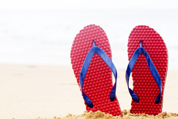 beach flip flops on tropical sand