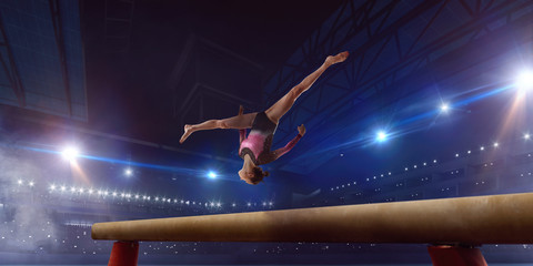 Female gymnast on professional arena.