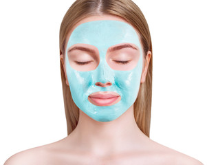 Blue vitamin facial clay mask on woman face.