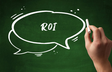 Hand drawing ROI abbreviation with white chalk on blackboard